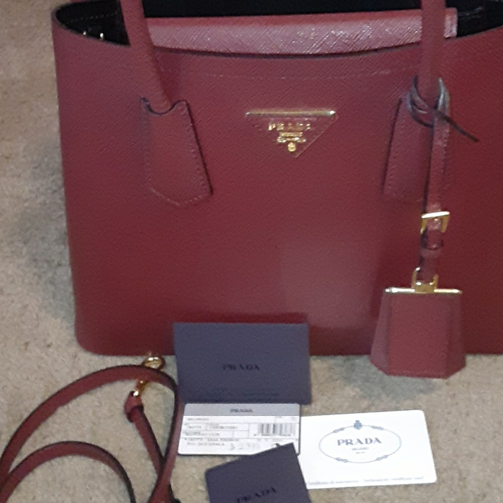 Red PRADA  hand purse  with a shoulder belt